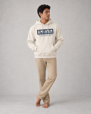 Amihan Hoodie in Bone, front on model with navy typographic print