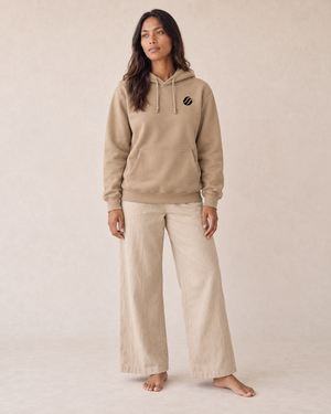 Babuyan Humpback Hoodie in Sandstone, front on model with black printed chest wave