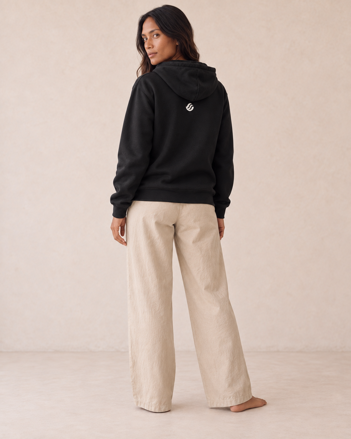 Batanes Flying Fish Hoodie in Black, back on model with small ivory printed wave
