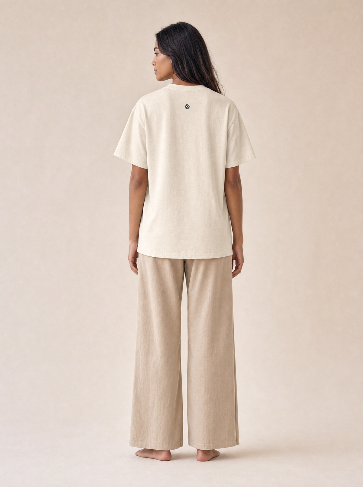 Coast Anthem Tee in Ivory, back on model with small wave mark below the collar