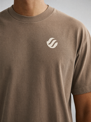 Coast Standard Tee in Sand, close-up of the ivory wave mark and collar