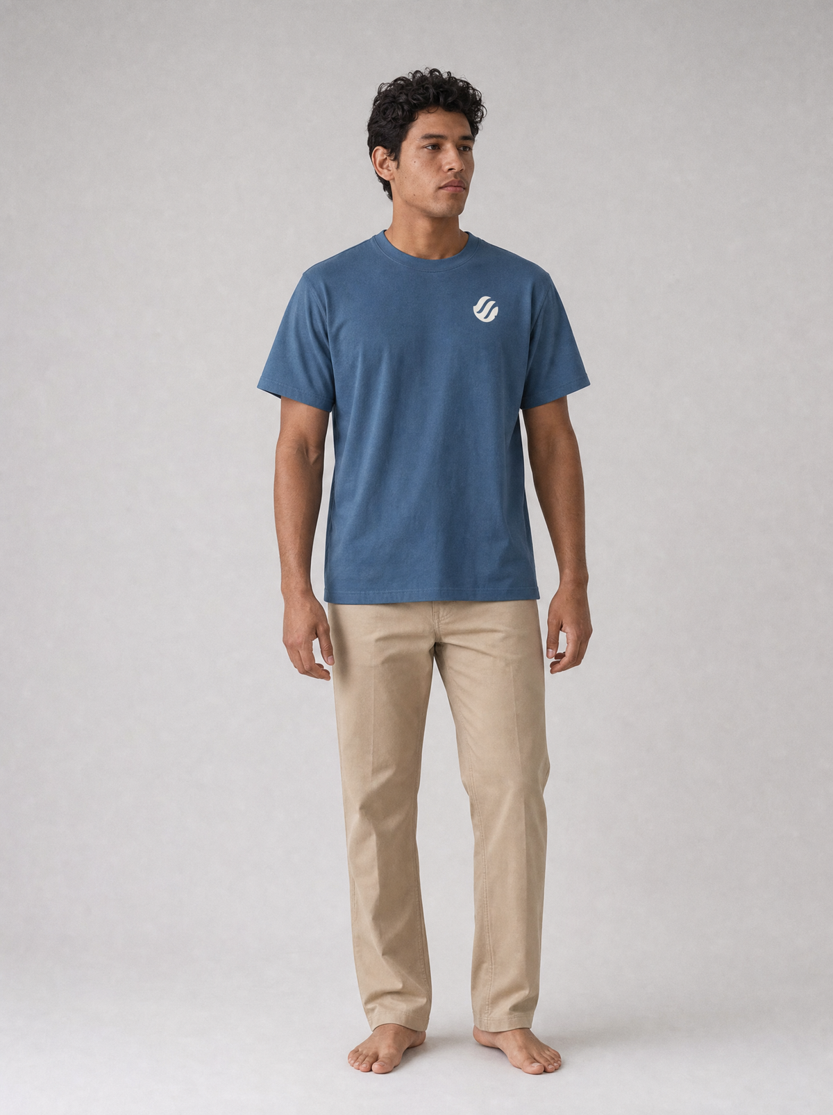 Coast Standard Tee in Navy with ivory wave mark, front on model
