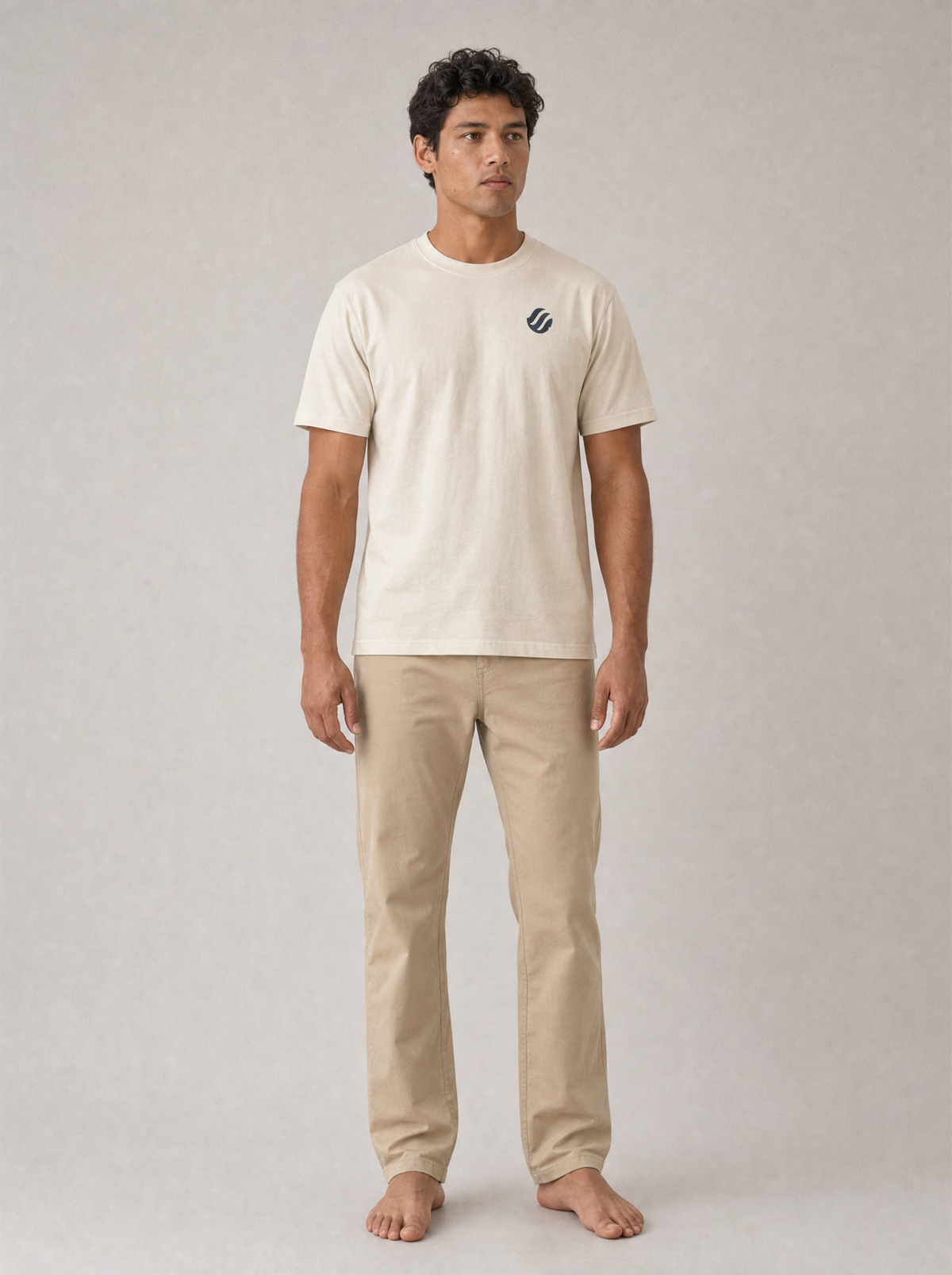 Coast Standard Tee in Ivory with navy wave mark, front on model